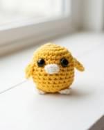 A small crocheted bird the color of the sun - Image 2