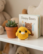 A small crocheted bird the color of the sun